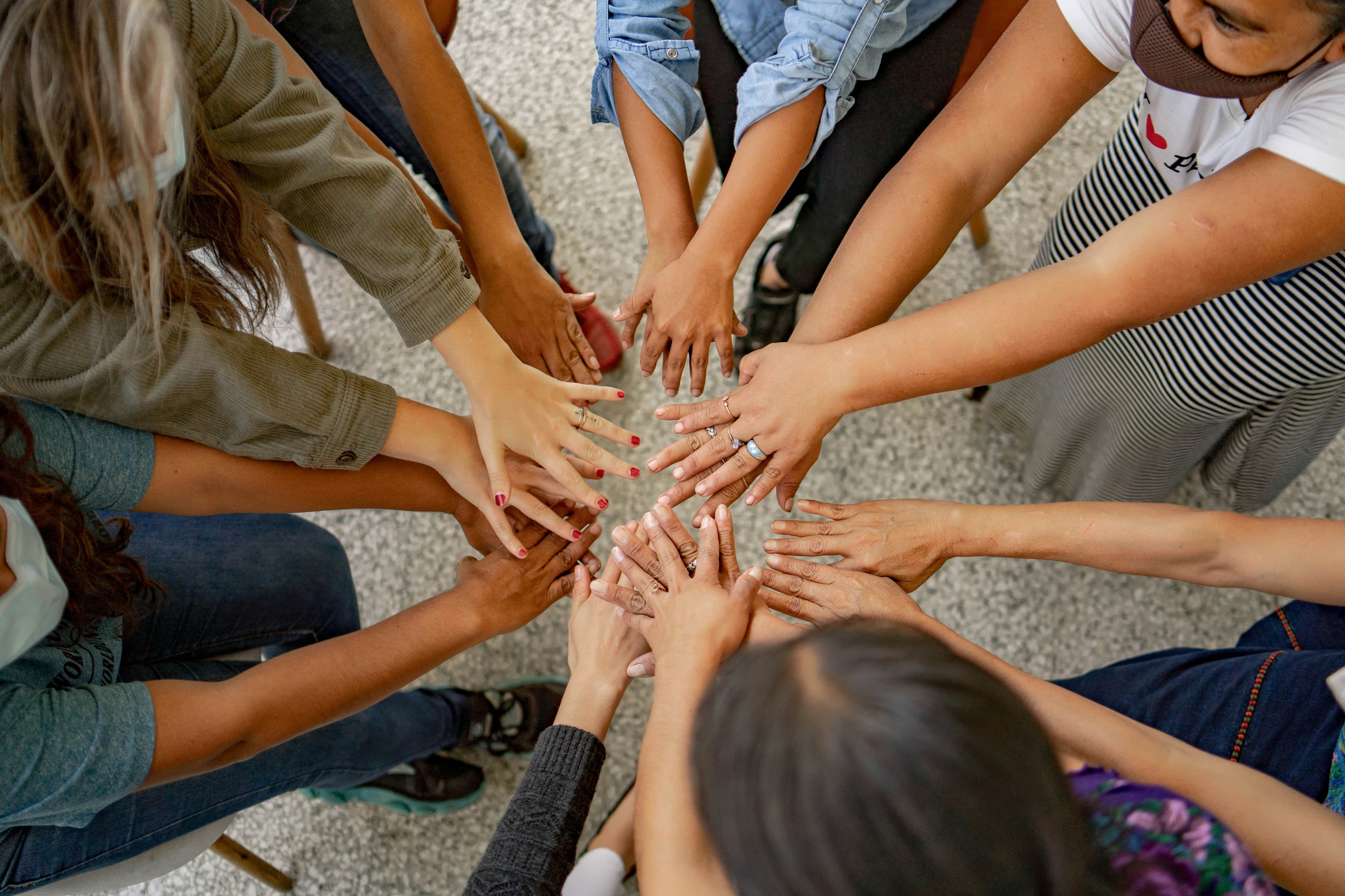 Hands joined together in a learning circle